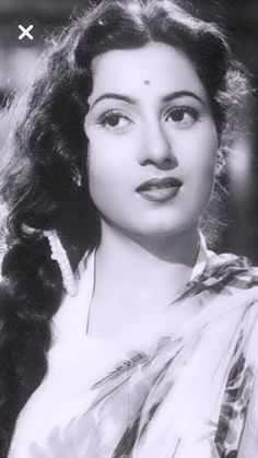 an old black and white photo of a woman with long hair wearing a sari