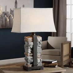 a lamp that is sitting on top of a table in front of a couch and chair