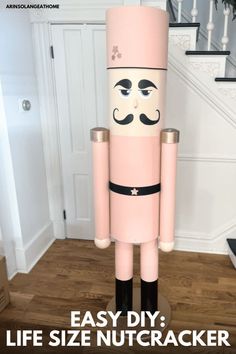 a life size nutcracker is standing in the middle of a room with stairs