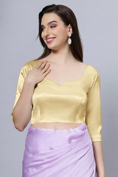 Our Satin Comfort Stretch collection blouses are made to impress and made to be worn all day. Made from the finest satin-cotton blend stretchable fabric, it holds its shape and shine while offering the comfort of stretchable material. Wear it with your favorite saree, as a crop top or lehenga choli! Item Type: Saree blouse / Crop top Product Features: Color: Gold Fabric: Satin Stretch Trim: Back Dori Neck Style: Leaf, Front & Back Sleeve Length: Elbow Sleeve Closure: Back Hook Padded: No Occasio Fitted Party Blouse In Solid Color, Fitted Satin Tops In Solid Color, Fitted Solid Satin Tops, Fitted Gold Padded Blouse, Fitted Solid Color Satin Tops, Elegant Stretch Gold Top, Elegant Gold Stretch Top, Elegant Fitted Satin Blouse Piece, Fitted Gold Satin Top