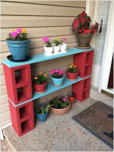 an outdoor shelf with potted plants on it