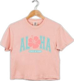 Casual Peach Tops With Letter Print, Pink Hawaiian Cotton Top, Pink Cotton Tops With Hibiscus Print, Tropical Letter Print Tops For Spring, Peach Letter Print Tops For Summer, Peach Letter Print Top For Summer, Peach Tops With Letter Print For Summer, Summer Peach Tops With Letter Print, Spring Tropical Letter Print Tops