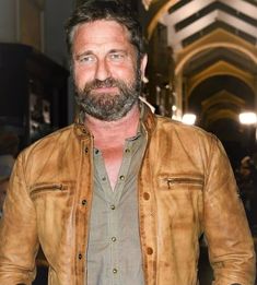 a man with a beard wearing a leather jacket