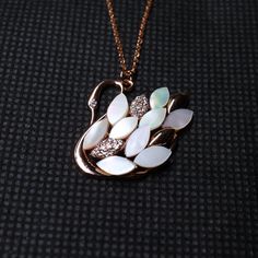 Swan Rhinestone Pendant & Necklace, New Trend Swan Opal Pendant Necklace with Long Chain, Elegant Swan Gold Plated Rhinestone Pendant & Necklace Stone Details → Shape: Round → Size: 1.00 ↣ Weight: 0.005 → Shape: Round → Size: 1.10 ↣ Weight: 0.006 → Shape: Round → Size: 1.30 ↣ Weight: 0.010 → Make: High Quality  ↣ Type: Moissanite ↣ Color: Colorless Handmade item Materials: Gold, Rose gold, White gold Chain style: Cable Style: Minimalist Jewelry style: Art deco Necklace length: Adjustable length Can be personalized Made to Order This jewelry set is available in silver, gold or pink gold(rose gold) color to match your dress Making Process: Handmade - Crafted by our experienced team The material used in these Necklace and earrings set are free from Lead, Nickel, Cadmium so it will not give yo Elegant Rose Gold Necklaces With Rhinestones, Elegant Rose Gold Necklace With Rhinestones, Dazzling Diamond Jeweled Necklace, Dazzling Jeweled Diamond Necklaces, Luxury Diamond Jeweled Necklaces, Elegant Pendant Necklace With Rhinestones, Luxury Diamond Jeweled Necklace, White Pendant Necklace With Rhinestones, Elegant Jeweled Necklace For Anniversary