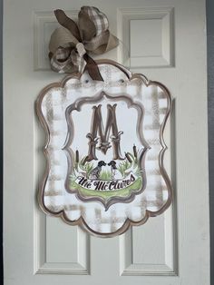 the front door is decorated with a monogrammed sign