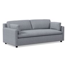 a gray couch sitting on top of a white floor