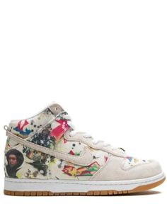 The Supreme x Nike SB Dunk High "Rammellzee" updates the iconic skate shoe with visual artist Rammellzee’s artwork. Crafted from light beige canvas, this model is accented with suede overlays on the toe, tongue, heel tab and even on the Swoosh. The gold 'Supreme' lace dubrae harkens back to the detailing found on Supreme’s early Nike SB collaborations from the 2000s. Casual Sneakers With Graphic Print And White Sole, Urban Skate Shoes With Graphic Print And Round Toe, Urban Round Toe Skate Shoes With Graphic Print, Urban Graphic Print Skate Shoes With Round Toe, Graphic Print Skate Shoes With Round Toe, Urban Skate Shoes With Graphic Print And Lace-up, Urban Sneakers With Graphic Print For Skateboarding, Sporty Sneakers With Graphic Print And Round Toe, Urban Skateboarding Sneakers With Graphic Print