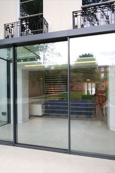 Rear glazed extension sees higher roof to the front elevation due to concealed drainage system hidden towards the back wall Glass Box Extension, Modern Patio Doors, Modern Conservatory, Sliding Door Window Treatments, Kitchen Extensions, Minimal Windows, Sliding Folding Doors, Room Extensions, Glass Extension