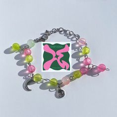 ★彡An adjustable bracelet inspired by TXT's 5th EP "The Name Chapter: Temptation". ★彡The bracelet in the pic has 14 beads, including a green and a pink bead as charms. ★彡Try NOT to expose the bracelet to water, like wearing it to the beach or showering with it. ★彡If you have any suggestions or questions, feel free to message me. I would be more than happy to help! Y2k Style Beaded Bracelets As Gift, Handmade Adjustable Y2k Beaded Bracelets, Handmade Y2k Style Bracelets Gift, Y2k Style Adjustable Silver Bracelets, Adjustable Silver Y2k Bracelets, Adjustable Silver Y2k Style Bracelets, Trendy Metal Beaded Bracelets For Friendship, Trendy Handmade Jewelry For Streetwear, Trendy Handmade Streetwear Jewelry