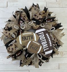 a wreath made out of burlocks and footballs with the word faith on it