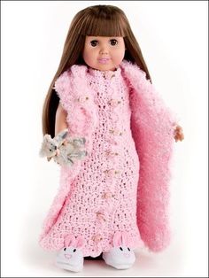 the doll is wearing a pink crocheted dress