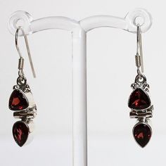 Make a statement with these elegant hand-crafted semi-precious stone earrings which feature red Garnet and rainbow Moonstone gemstones.  Stone: Garnet Colour: Red Metal: 925 Solid Sterling Silver  Drop Length: 3.5cm  Earring Width: 0.7cm Materials: Each one-of-a-kind piece of jewellery is lovingly hand crafted using top quality semi-precious natural gemstones and solid 925 sterling silver, so that you can treasure your piece for a lifetime.  Gift Boxes: each unique piece is also beautifully pack Classic Red Jewelry As A Gift, Red Sterling Silver Jewelry As Gift For Her, Nickel-free Ruby Jewelry For Gifts, Garnet Gemstone Drop Earrings, Ruby Drop Earrings As A Gift, Nickel-free Ruby Jewelry Gift, Ruby Jewelry With Matching Earrings For Gift, Ruby Jewelry With Matching Earrings As A Gift, Ruby Jewelry Set With Matching Earrings As A Gift