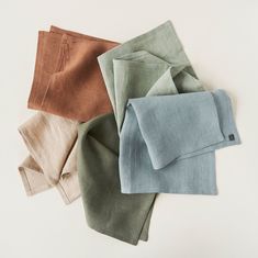 four different colors of linen folded on top of each other