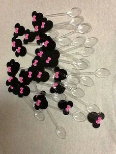 a bunch of wine glasses with pink and black mickey mouse decorations