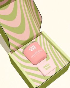 an open box with a pink and green item in it