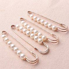 five pairs of hooks with pearls on them