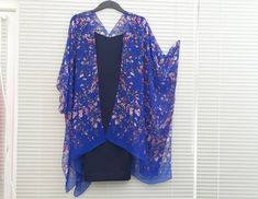 "This versatile kimono cardigan can be worn as a beach cover-up or with a  dress or camisole. Suitable for daywear or eveningwear, the perfect addition to any wardrobe.  Ideal for holidays and travelling, even backpacking as it takes up nearly no room in your travel bag and is light. - Blue Kimono Cardigan  - Wide Sleeves - Draping perfectly - Light weight sheer soft fabric - One size fits most - Floaty fabric - Light and breathable - V neck style at the back *Please note the dress is not includ Blue Floral Print Cover-up For Spring, Blue Floral Print Spring Cover-up, Spring Blue Floral Print Cover-up, Floral Print Shawl Kimono For Spring, Spring Floral Print Shawl Kimono, Blue Kimono With Kimono Sleeves For Daywear, Spring Shawl Kimono With Floral Print, Blue Floral Print V-neck Kimono, Blue V-neck Kimono For Spring