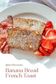 a white plate topped with french toast and strawberries