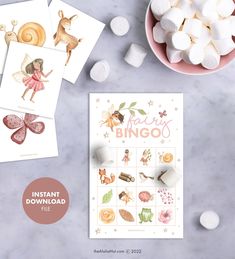 the printable fairy bingo game is next to marshmallows and other items