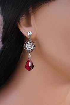 "A great earring for the bridal party or bridesmaids that they can also enjoy wearing after the wedding.  A gorgeous Swarovski crystal dangles from a antiqued silver Swarovski rhinestone filigree flower giving this earring a vintage feel.  They are finished on a post.  It is pictured in clear and ruby but see above for other color choices.  These measure about 1 3/4\" in length." Red Clip-on Jewelry For Wedding, Victorian Clip-on Jewelry For Wedding, Victorian Clip-on Wedding Jewelry, Jeweled Drop Earrings For Wedding, Elegant Jeweled Crystal Earrings For Wedding, Victorian Style Clip-on Earrings For Wedding, Victorian Dangle Bridal Earrings For Wedding, Teardrop Jeweled Bridal Earrings For Wedding, Crystal Jeweled Bridal Earrings For Wedding