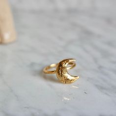 This ring is handmade by me and moulded bronze. Ring size is adjustable you can use for your every finger. Ring is 18 k gold. Crescent size is: 1.5 cm in height. Adjustable Moon Shaped Celestial Rings, Adjustable Moon-shaped Celestial Rings, Celestial Half Moon Gold Jewelry, Celestial Adjustable Open Ring Jewelry, Gold Plated Moon Phase Jewelry, Adjustable Celestial Open Ring Jewelry, Adjustable Crescent Brass Jewelry, Celestial Half Moon Jewelry Gift, Adjustable Moon Phase Ring For Gift