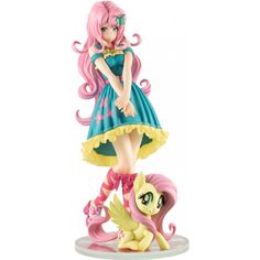 a figurine of a girl with pink hair and blue dress standing next to a pony