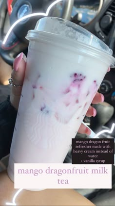 a woman holding up a cup of ice cream in her hand with the caption mango dragon fruit milk tea