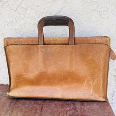 Looking for that retro look when traveling to the office or local coffee shop to get some work done? Then look no further then this great shabby chic looking soft tan leather zip-up briefcase. This case is the perfect size for your laptop or device and it also stretches a little if you want to fill it with important papers. I believe it to be unbranded though one can just make out the letters "W T B" on one side. This may have been the (customized) initials of the previous owner?  You're on to a winner with this fabulous retro case. It measures 17" wide, 11" height x 3 1/4" depth. (It is 14" high including the retractable handles). It weighs 2lb 4oz. CONDITION, PLEASE READ: This briefcase shows definite signs of age and wear as all great vintage items do. Examine all the pictures closely. Vintage Rectangular Business Case, Vintage Rectangular Briefcase For Business Trips, Vintage Leather Case For Business Trips, Vintage Leather Cases For Business Trips, Vintage Briefcase With Luggage Sleeve For Daily Use, Vintage Leather Case For Everyday Use, Vintage Rectangular Cases For Business Trips, Vintage Leather Cases For Everyday Use, Vintage Business Case, Rectangular