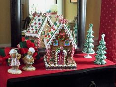 a table topped with lots of different types of gingerbread houses