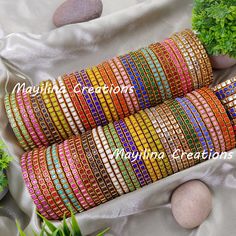 Mayilina Creations provides a perfect bangle with finest finishing, that makes your complete attire unique. Mayilina Creation is your one stop destination for a handmade silk thread bangles for all occasions. We do have perfect return gift bangles for Wedding, Baby Shower, Housewarming, Birthday etc. You can customize your order (any alterations in color or number of bangles), please contact seller to satisfy your requirements. Product color may vary slightly due to photographic lighting sources or your monitor settings. * Materials Plastic/ Metal base bangles, wrapped with fine silk thread and embellished with kundans. * Use and purpose Silk thread bangles for wedding functions. * Dimension Indian Bangle Size (inner diameter in cms) 2.2 - 5.4 cm 2.4 - 5.7 cm 2.6 - 6 cm 2.8 - 6.3 cm 2.10 - Pink Handmade Bracelet For Diwali, Handmade Pink Bracelets For Diwali, Handmade Pink Bracelet For Diwali, Traditional Adjustable Multicolor Bangle, Bohemian Multicolor Bracelets For Navratri, Multicolor Cutdana Bangle Bracelets, Handmade Bollywood Bangle For Festivals, Handmade Multicolor Bangle For Diwali, Multicolor Bangle Bracelet For Diwali