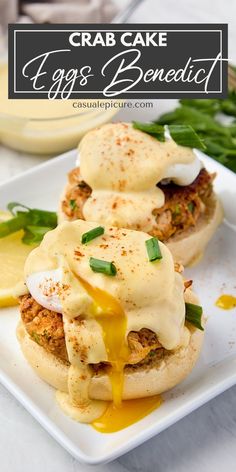 crab cake eggs benedict on a plate with lemon wedges and scallions in the background