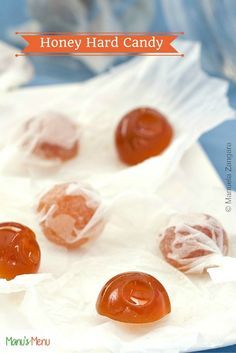 honey hard candy is sitting on top of some wax paper with the words, honey hard candy