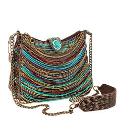 Strand after strand of beads in tones of turquoise, garnet, bronze & gold drape across the front of this crossbody handbag creating a fun boho feel that makes a bold fashion statement. It's roomy interior, padded shoulder strap and secure zipper and magnet flap closure make it the perfect companion for festival outings or everyday adventures. 9.75 x 3.75 x 7" Strap Length End to End: 49" Strap Drop: 24.25" Non-removable crossbody chain strap with padded shoulder piece zipper and magnetic flap cl Turquoise Crossbody Shoulder Bag With Detachable Strap, Bohemian Crossbody Shoulder Bag As Fashion Accessory, Bohemian Crossbody Shoulder Bag, Beaded Brown Shoulder Bag For Travel, Travel Brown Beaded Shoulder Bag, Multicolor Beaded Crossbody Shoulder Bag, Bohemian Evening Crossbody Shoulder Bag, Beaded Crossbody Shoulder Bag For Travel, Bohemian Crossbody Shoulder Bag For Party