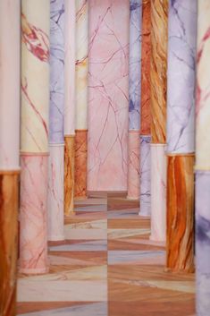 an abstract photo of marble columns and flooring in pink, blue, yellow and purple colors