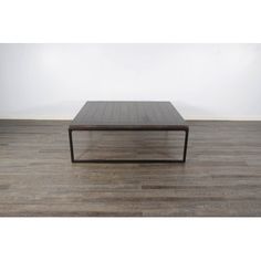 a square coffee table on a wooden floor