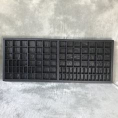 a large black shelf with many compartments on it