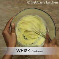 someone mixing batter in a glass bowl with a whisk on the top and bottom