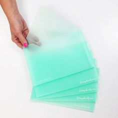 a person using a knife to cut up some glass sheets on top of a table