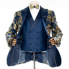 a mannequin wearing a tuxedo and jacket with gold designs on it