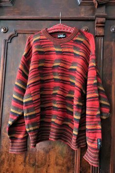 Beautiful True Vintage Carlo Colucci knit sweater from the 1990s. Made from a high quality wool blend fabric with multi color, structured wave knit in a warm color palette. Crew neck, relaxed cut, wide sleeves. Striped neck, cuffs and waistband. Carlo Colucci brand patch above the left cuff. Unisex. BRAND: Carlo Colucci ERA: 1990s COLOR: Red, sand, mustard, brown, khaki FABRIC: 70% new wool, 30% acrylic SIZE: Vintage men's size 52, fits best men's size L, but can also be worn by women - please c Retro Striped Knitted Sweater, Winter Jacquard Knit Striped Sweater, Winter Striped Jacquard Knit Sweater, Striped Jacquard Knit Sweater For Winter, Striped Wool Sweater With Long Sleeves, Striped Wool Sweater With Crew Neck, Striped Wool Crew Neck Sweater, Cheese Whiz, Vintage Knit Sweater