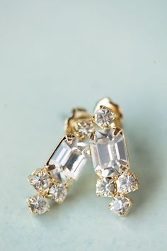 "Indulge in luxury with our EVAN EARRINGS in GOLD. These breathtaking earrings feature an Emerald Cut Crystal and Rhinestone Cluster Frame, perfect for adding an elegant touch to any look. With a delicate and art deco inspired design, they make the ultimate gift for a classic bride or bridesmaid. Elevate your style with the timeless beauty of our Evan Earrings. *Measures 3/4\" x 1/2\" *Made of Clear Preciosa Crystals *5K Gold Plated Brass *Stainless Steel Post Back *Ships in 1-5 Business Days *R Crystal Bridal Earrings, Gold Bridal Earrings, Earrings Art, Back Jewelry, Rhinestone Wedding, Earrings Crystal, Art Deco Earrings, Wedding Jewelry Earrings, Zirconia Earrings