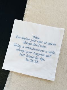 a piece of cloth with a poem written on it sitting on top of a table