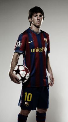 a man holding a soccer ball in his right hand and wearing a uniform with the number 10 on it