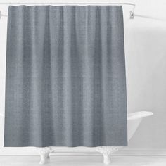 a gray shower curtain in a white bathroom