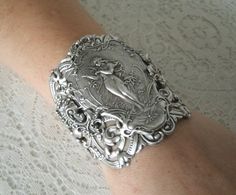 "This beautiful silver plated cuff bracelet has a silver plated art nouveau maiden, silver plated chain and lobster clasp. 2.75\" at the widest part. Adjustable." Victorian Hallmarked Silver Bracelets, Victorian Silver Hallmarked Bracelet, Victorian Hallmarked Silver Bracelet, Handmade Ornate Cuff Bracelet, Unique Antique Silver Bracelet As Gift, Unique Antique Silver Bracelet For Gift, Victorian Metal Bracelet For Gift, Victorian Sterling Silver Bracelet, Victorian Adjustable Silver Bracelets