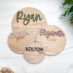 three wooden coasters with names on them