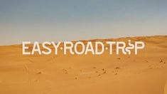 the word easy road trip written in white over a desert landscape