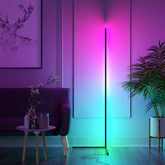 a living room with purple and blue lighting on the wall, plants in vases