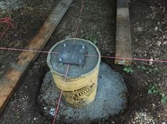 a yellow bucket sitting on top of a cement slab