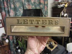 a person holding up a sign that says letters